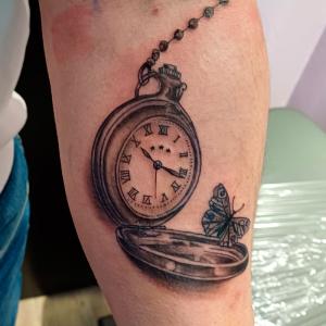 Tatouage bras montre et papillon